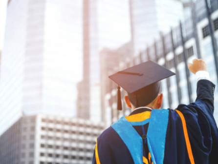 Recent graduate celebrates in his cap and gown