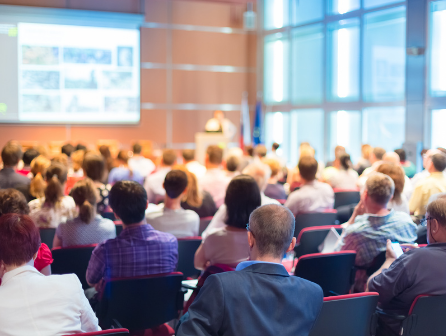 Corporate workers gather for engaging presentation